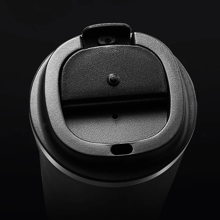 Black coffee cup lid on a black background