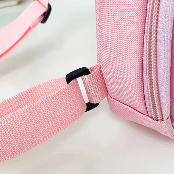Close-up of a pink bag with a strap on a light background