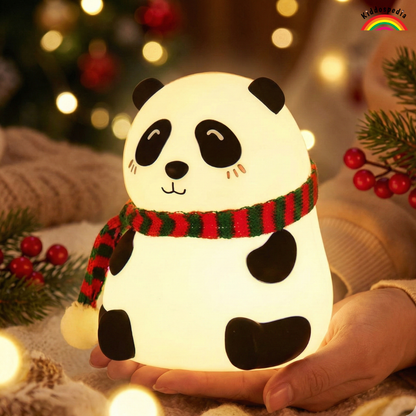 Panda-shaped night light with a red and green scarf held by a hand against a festive background.