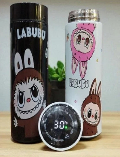 Two cartoon-themed water bottles with a digital thermometer on a wooden surface.