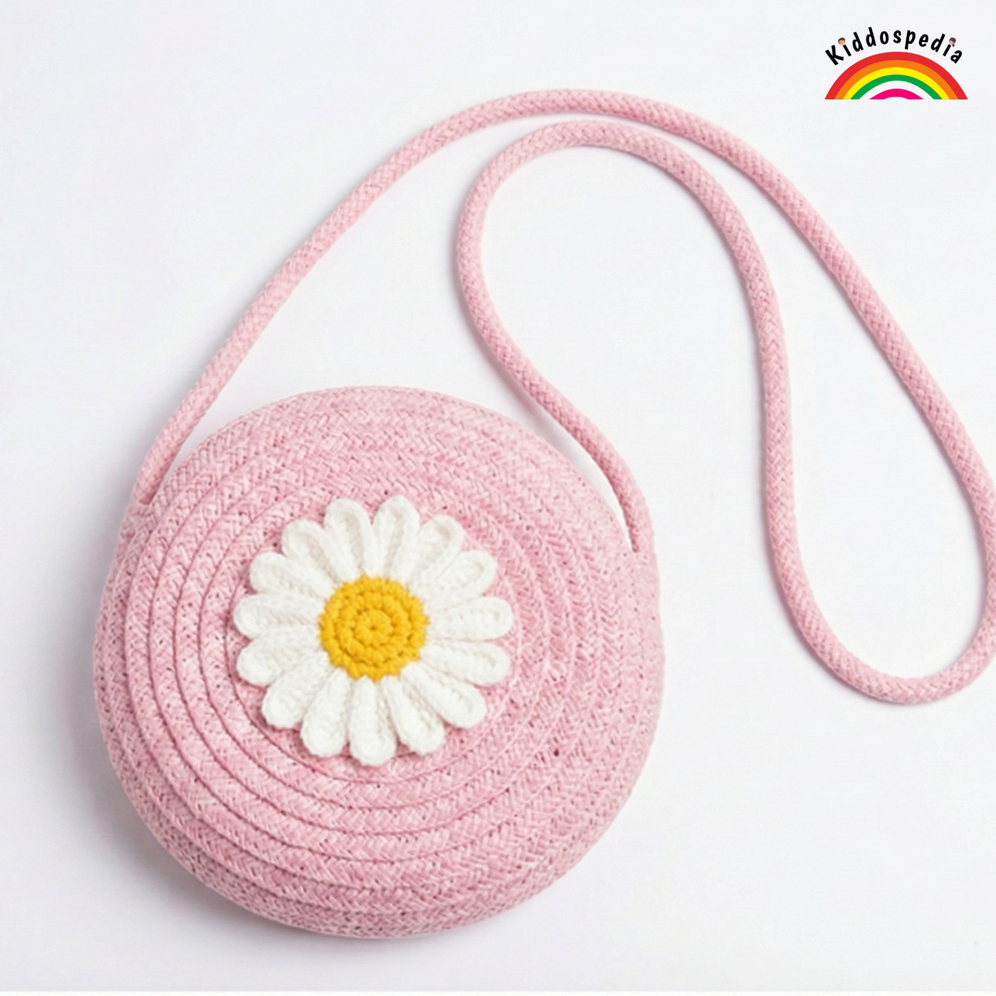 Pink crocheted bag with a white daisy flower on a light gray background, featuring the Kiddospedia logo.