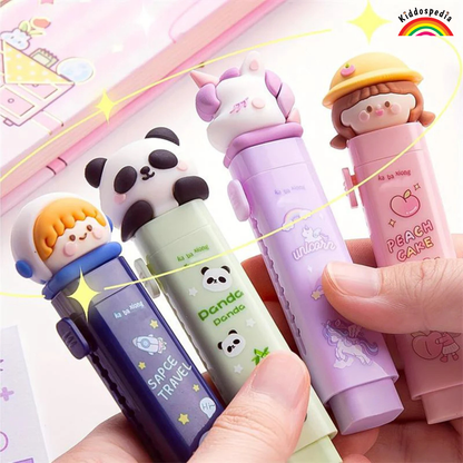 Four colorful pens with cartoon character designs held by a hand against a bright background.